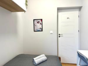 a bedroom with a bed and a white door at MMRent Tiger Room in Gdańsk