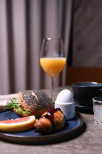 a plate of food and a glass of orange juice at Quality Hotel Carlia in Uddevalla