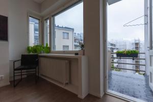 a room with a large window with a desk and a radiator at Luxury Nordic Loft with Great Kitchen and Location in Helsinki