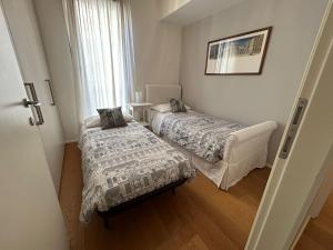 a bedroom with two beds and a window at San Francesco Charming apartment -Treviso in Treviso