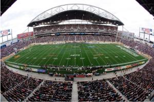 a crowd of people watching a football game in a stadium at Elegant 6 Bedroom House Near U of Manitoba in Winnipeg