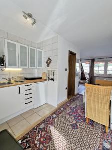 a kitchen with white cabinets and a table and chairs at Mosel View in Zell an der Mosel