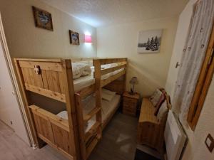 a room with two bunk beds in a house at Résidence Andromède in Belle Plagne