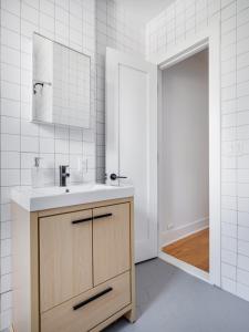 W łazience znajduje się umywalka i lustro. w obiekcie Modern Three Bedroom Brooklyn Condo-Hotel w mieście Brooklyn