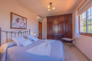 a bedroom with a large bed with blue sheets at Casa Nieves in El Paso