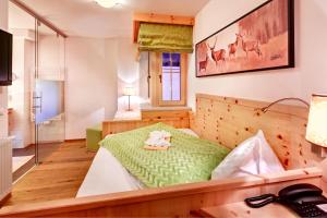 Postel nebo postele na pokoji v ubytování Biohotel Castello Königsleiten