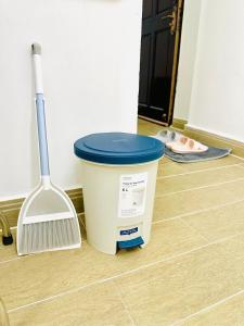 a bucket of paint and a broom on a floor at Cozy & Quiet 1BR Oasis in the heart of Ho Chi Minh City in Ho Chi Minh City