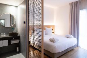 a hotel room with a bed and a mirror at Paxton Paris MLV in Ferrières-en-Brie +44 photos