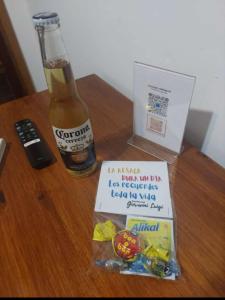 a bottle of beer and a box of snacks on a table at Giovanni Luigi in Villa General Belgrano