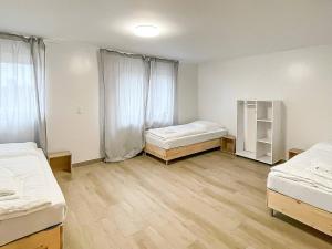 an empty room with two beds and a window at T&K Apartments - Wegberg - 3-6 Zimmer Apartments in Wegberg