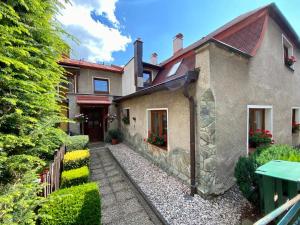 a house with a pathway in front of it at Apartmán Mája in Rumburk