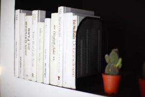 a row of books on a shelf with a plant at Blu Monkey Hub and Hotel Phuket Town- Free All Day Coworking space in Phuket Town