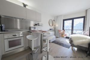 a kitchen with a table and chairs in a room at NID DOUILLET DE FLAINE in Flaine