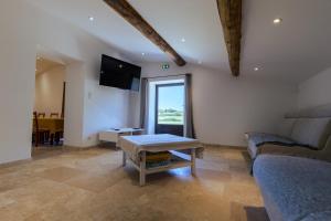 a living room with a couch and a table at Le Moulin de Lavon in Gargas