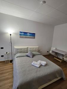 ein Schlafzimmer mit einem großen Bett mit zwei Handtüchern darauf in der Unterkunft Appartamenti ClesioResidenceBuonconsiglio in Trient