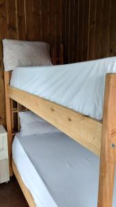 a couple of bunk beds in a room at Casas Paz e Amor Praia do Rosa Sunset e Sunrise in Imbituba