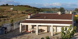 a white house with a red roof on top of it at Casa das Lagoas com piscina aquecida exclusiva in Bragança
