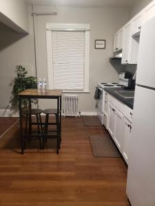 a kitchen with a table and a table and chairs at The City-Side at Silver Lake *NEW 1-BED RM APT in Providence