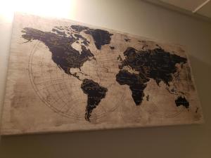 a map of the world hanging on a wall at The City-Side at Silver Lake *NEW 1-BED RM APT in Providence