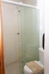 a glass shower in a bathroom with a toilet at Hotel Grandville II in Palmeira dos Índios