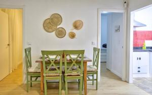 a dining room with a wooden table and chairs at Apartamento Triana in Seville