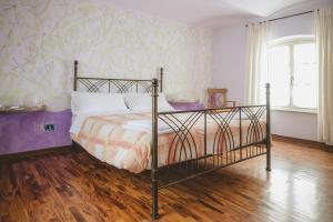 a bedroom with a bed and a wall mural at Casa del Sole in Castagnole Lanze +33 photos