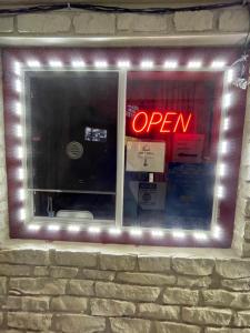 a neon sign in the window of a restaurant at Relax Inn Copperas Cove in Copperas Cove