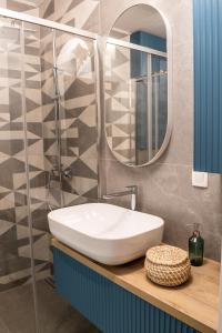 a bathroom with a sink and a mirror at Ljubljana Urban Apartments - Quiet Stay & Free Parking in Ljubljana +25 photos