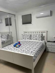 a bedroom with a white bed with a mirror at Palmas View Premium 7 in Humacao