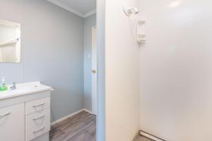 a bathroom with a sink and a mirror at Home In Naseby in Naseby