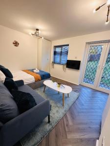 a living room with a couch and a bed at R1 - En-suite Private Room in Birmingham House - Quinton in Birmingham