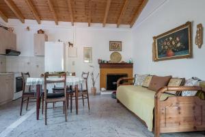 a living room with a couch and a table and a kitchen at Beautiful cottage house at Mesokampos in Samos
