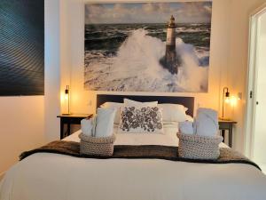 a bedroom with a bed with a picture of a lighthouse at Nuevo Hola Madrid BIS in Madrid