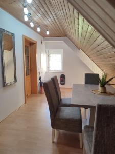 a dining room with a table and chairs and a staircase at Be Home! 2. Apartment Gratkorn in Gratkorn +10 photos