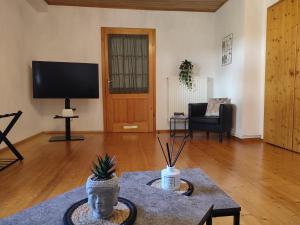 a living room with a statue of a head on a table at Be Home! 2. Apartment Gratkorn in Gratkorn