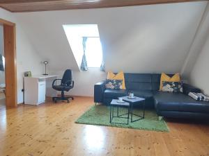 a living room with a blue couch and a table at Be Home! 2. Apartment Gratkorn in Gratkorn