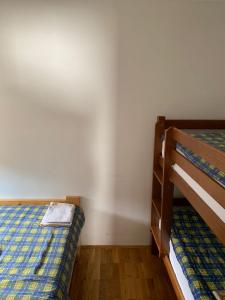 a bedroom with two bunk beds and a newspaper on the bed at Apartmani Košuta- Ljiljana Đokanović in Jahorina