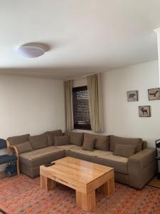 a living room with a couch and a coffee table at Apartmani Košuta- Ljiljana Đokanović in Jahorina