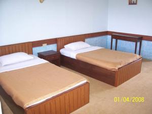 1 dormitorio con 2 camas y 2 mesitas de noche en Saichonview Riverkwai Resort, en Ban Dan Makham Tia