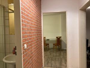 a room with a brick wall and a bathroom with a sink at Schöne Dachgeschosswohnung in Essen