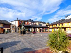 an empty street in a town with buildings at Casa Mencía in Camponaraya