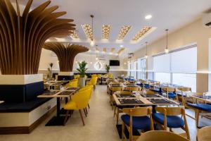 蒙巴薩的住宿－Premium Inn Mombasa City，用餐室配有桌子和黄色椅子