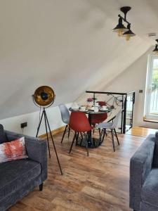 a living room with a table and chairs at The Willow (Alton Towers, Animals, Peak District) in Denstone