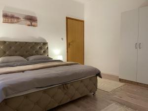 a bedroom with a large bed in a room at Hills Holiday House in Mostar +38 photos