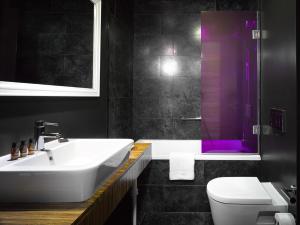 a bathroom with a sink and a toilet and a shower at The ICON Hotel & Lounge in Prague