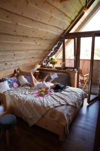 a woman laying on a bed in a room at Odludomki in Smerek