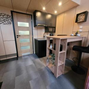 a small kitchen with a counter and a table at Tiny House 2 Dedinky Privat Wellness in Dedinky +8 photos