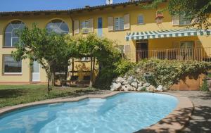 a swimming pool in front of a house at Casa del Sole in Castagnole Lanze