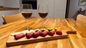 a wooden table with two glasses of red wine at Apartmán na Pasekách in Bystrzyca