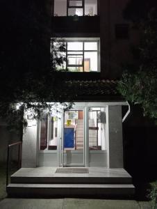 a door on a building with stairs in front at Apartman Dionis SM in Sremska Mitrovica